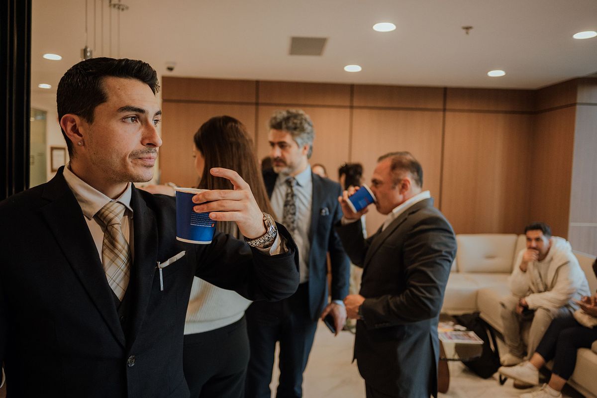 business person enjoys beverage in an office setting