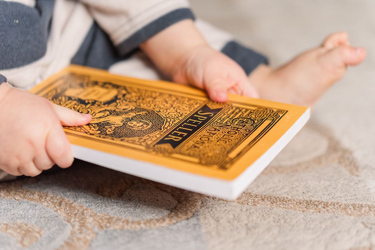 baby hands holding christian book while sitting, in Cranberry Township, PA