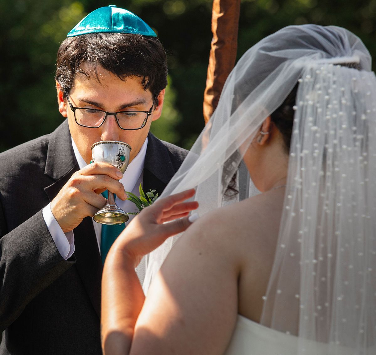 Jewish Groom drinking wine at wedding ceremony
