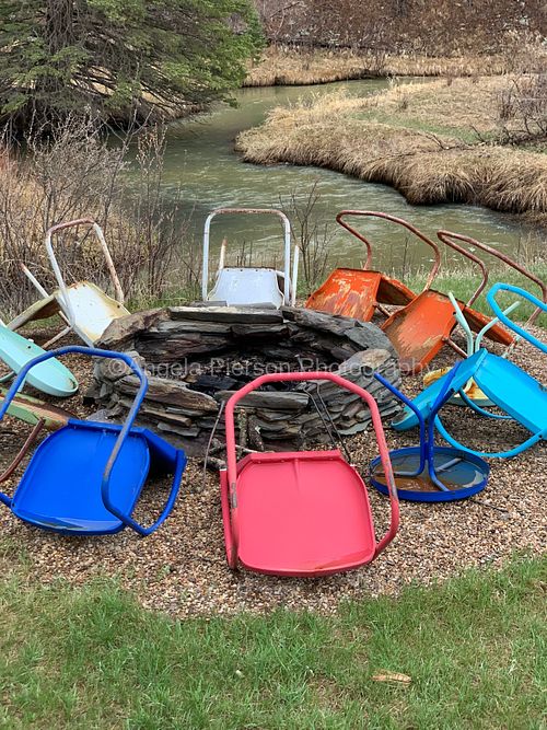 Colorful chair turned upside down around a fire pit
