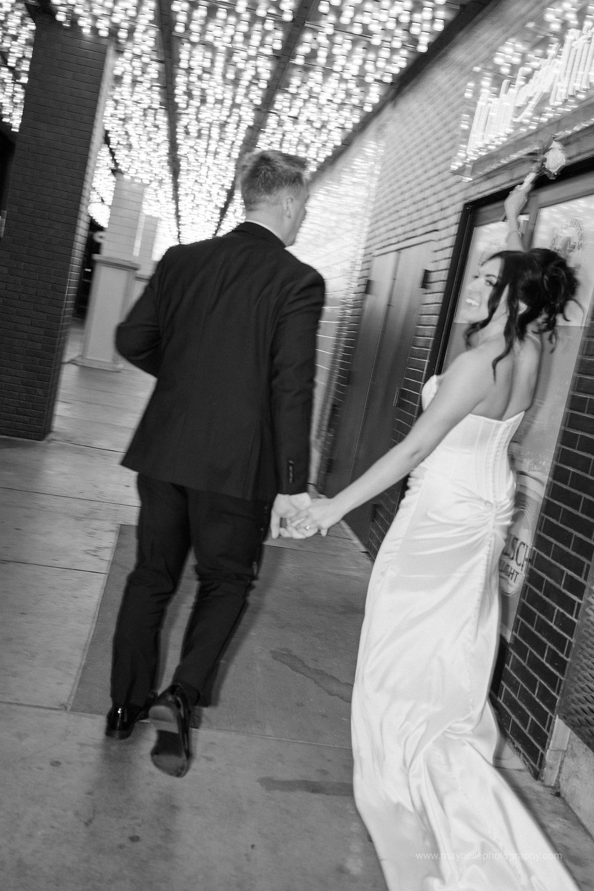 Romantic elopement photos at Carousel Bar in Downtown Las Vegas with couple celebrating with champagne