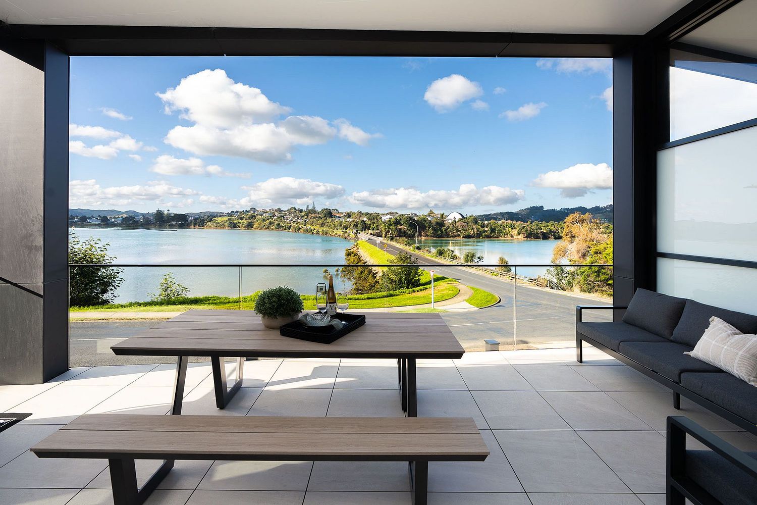 Architectural balcony photography overlooking the Raglan town and estuary by Flax Cove Studio.
