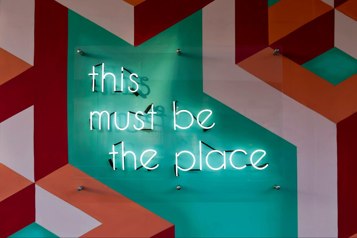 a sign on a wall that reads "this must be the place"