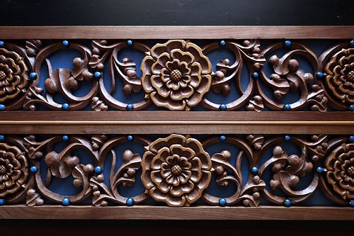 hand-carved rose and vine panel with liturgical blue background