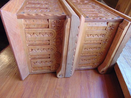 showing the carved cherry boxes next to each other from the side