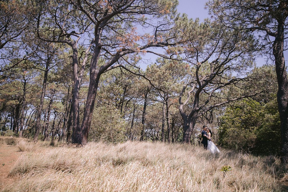 Romantic wedding photo of the bride and groom embracing each other at She Oak Grove, Centennial Park.