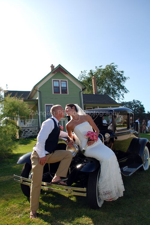 Bride and Groom kissing on top of a vintage black car- rapid city photographer