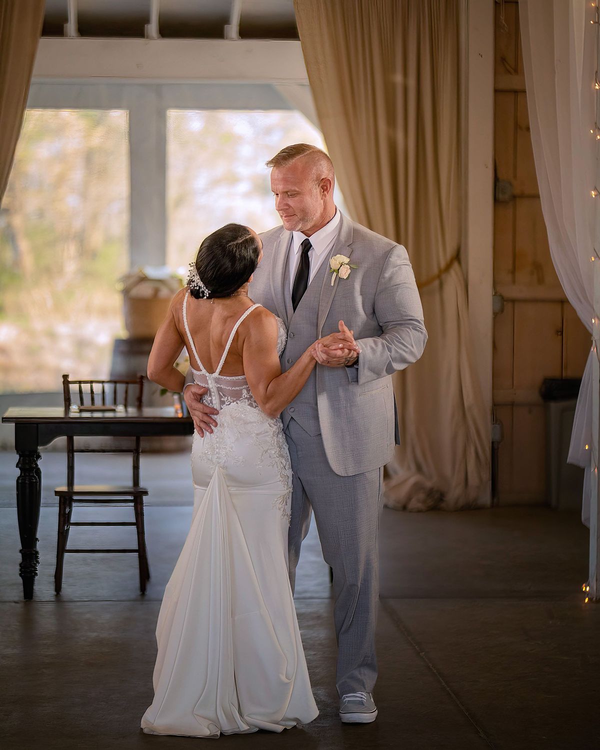 couple dancing first dance documented with natural light photography at kylan barn