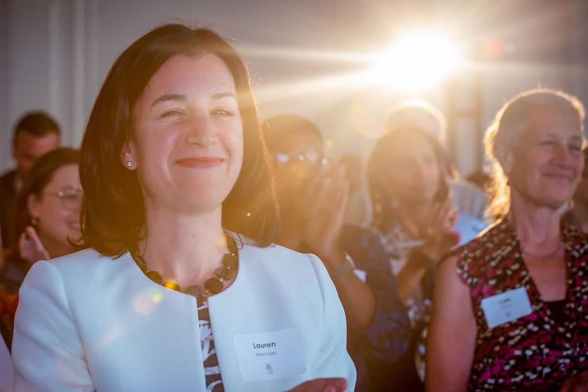Corporate event photography capturing an executive applauding during a recognition event in Philadelphia, emphasizing authentic engagement, leadership presence, and meaningful connection in professional spaces.