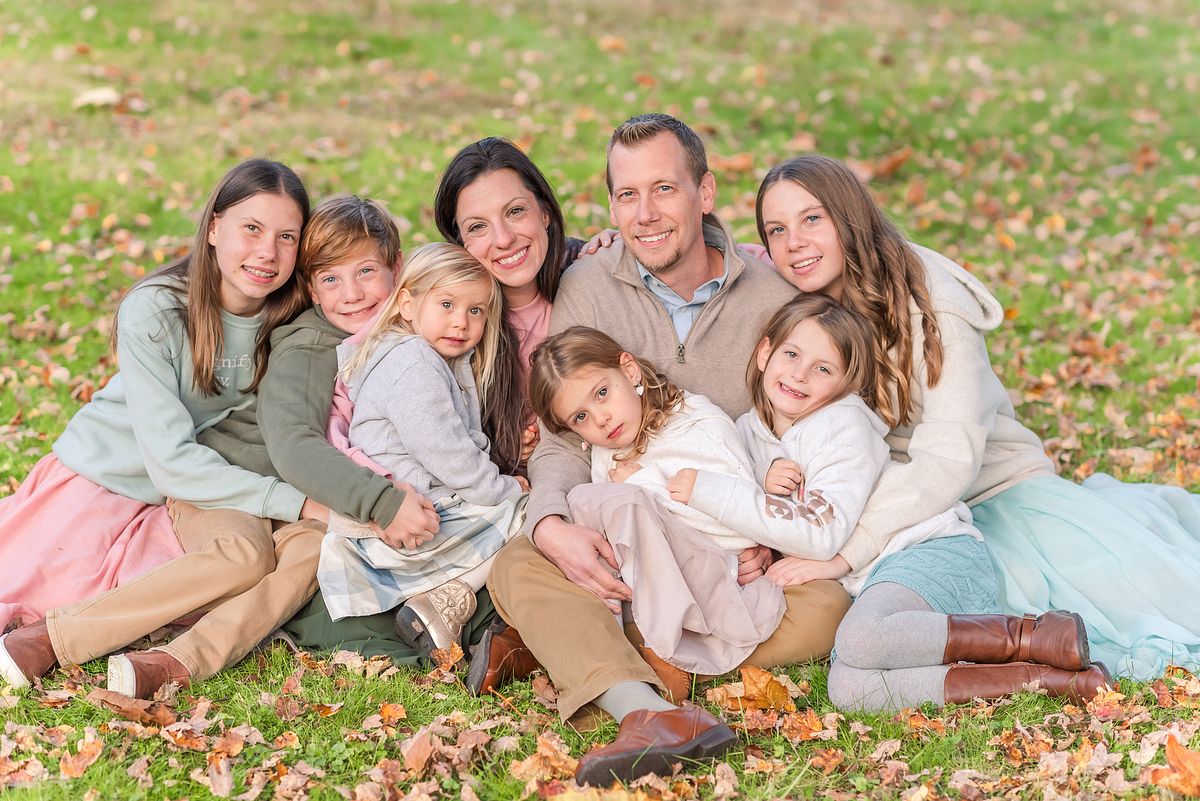 Family of eight cozy together in fall Brush Creek Park with Cranberry Township, PA newborn photographer