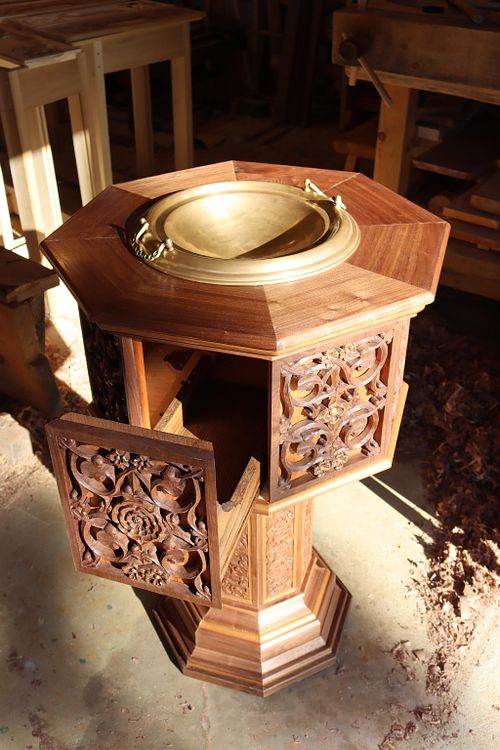 showing the secret drawer in the baptismal font to hold the necessary items for baptism