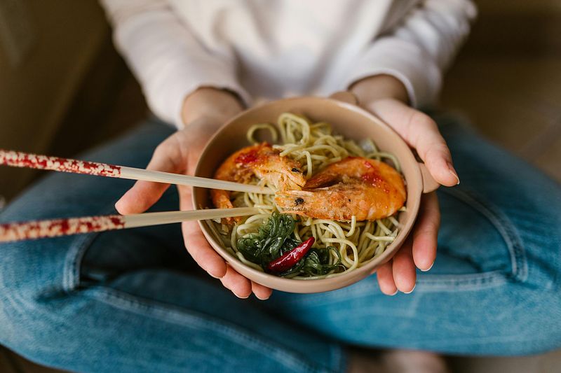 bowl of healthy protein rich foods held by a menopausal woman