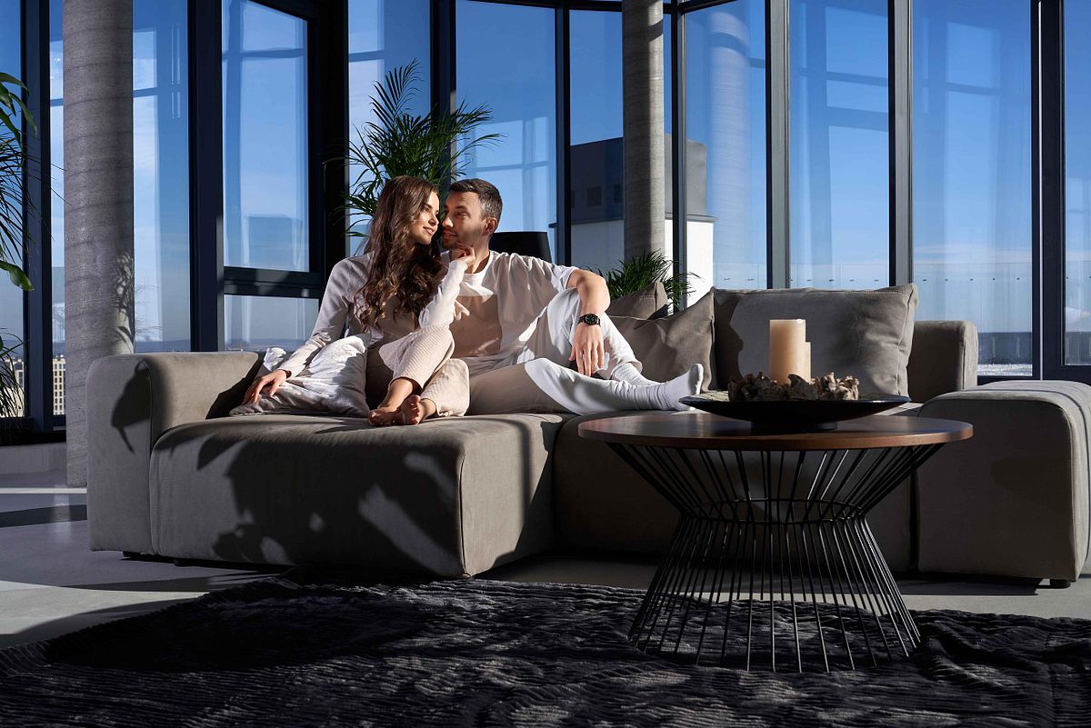 Happy couple resting at home with good mood.