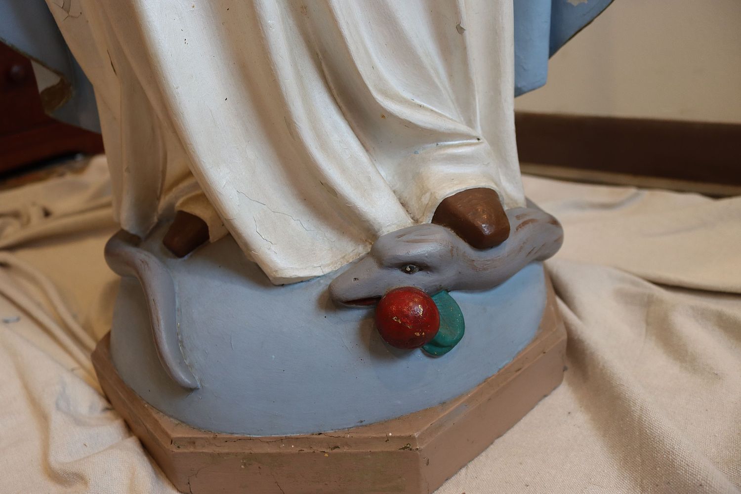 Snake at bottom of Mary statue before restoration