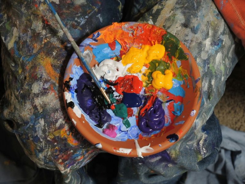Colour paintings on a pot with a brush