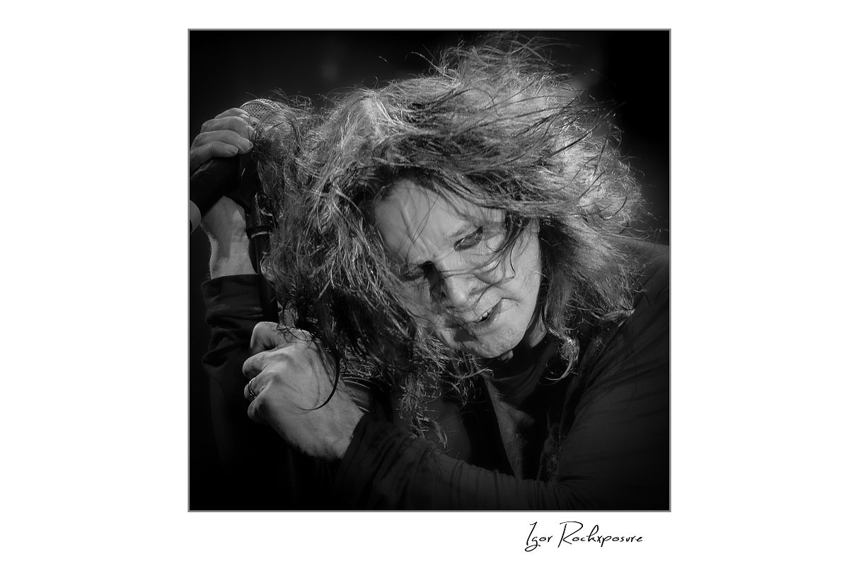 Ozzy Osbourne of Black Sabbath captured in an intense black and white close portrait with windblown hair and dramatic expression