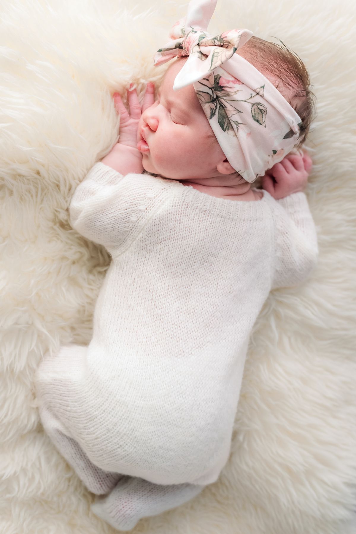 newborn baby girl sleeping in white pajamas and flower headband on cozy rug with cranberry township, pa newborn photographer