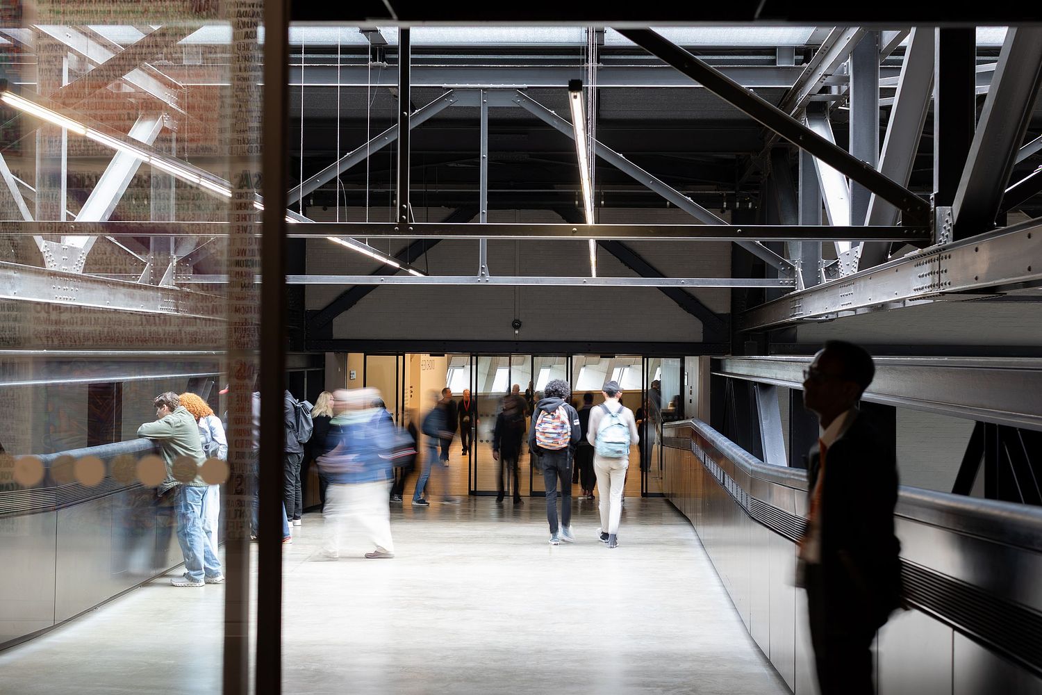 Blurred motion of visitors walking inside modern museum, Stockholm lifestyle photography