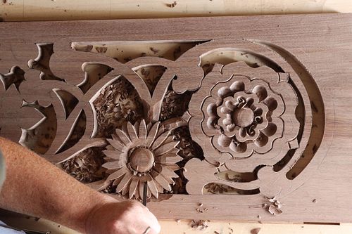 process photo of carving daisy on door panel