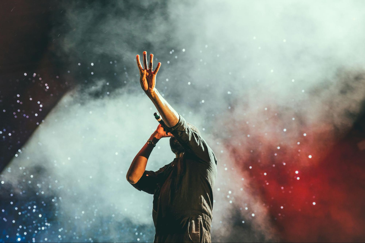 Image of a musician singing in a concert