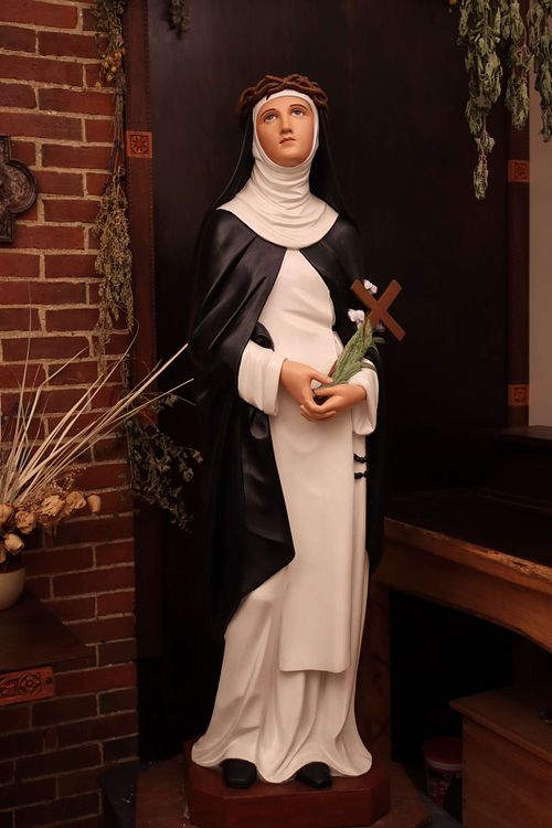 Saint Catherine Statue Restoration after repainting by Kelly Baker of Contrasts Woodcarving for Holy Trinity Catholic Church in Somerset, Ohio.