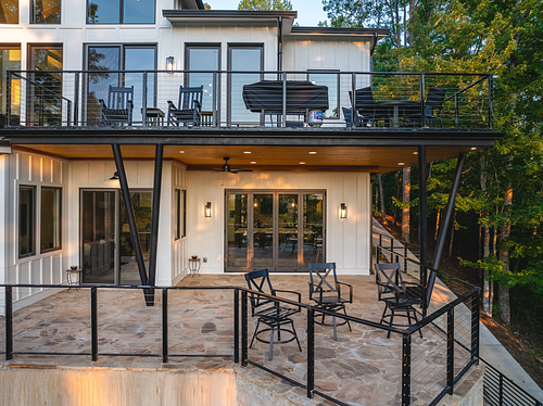 Patio projection to create a lake look out wrapped in cable rails