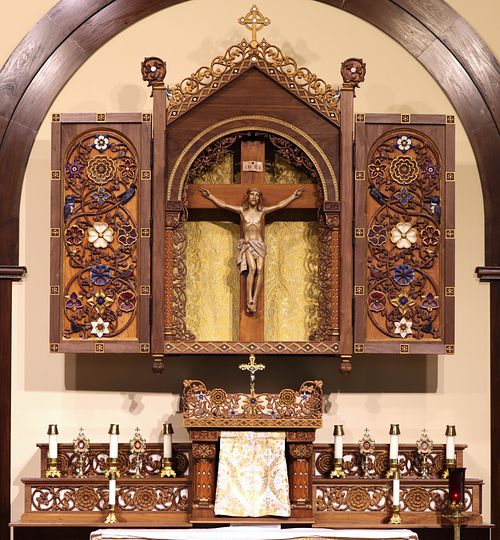 The altarpiece above the main altar, tabernacle, and gradines that form the high altar for the parish.