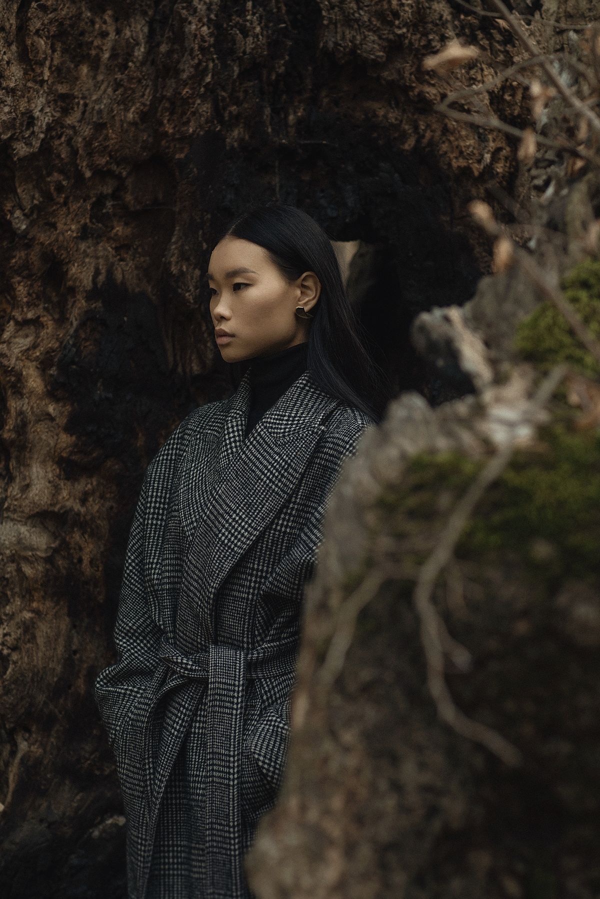 Portrait of a model wearing a winter coat and a black turtle neck in a broken tree. Abstract portrait of a model wearing. Photographed by Filianna Karamanli.