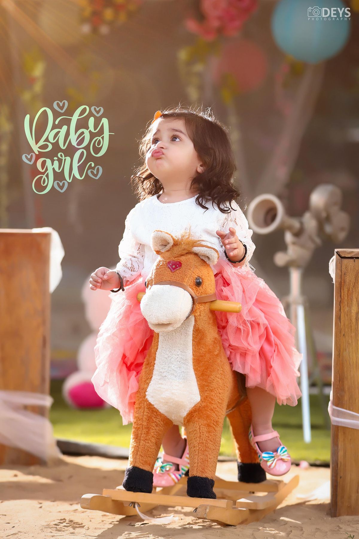 Baby riding toy horse shoot