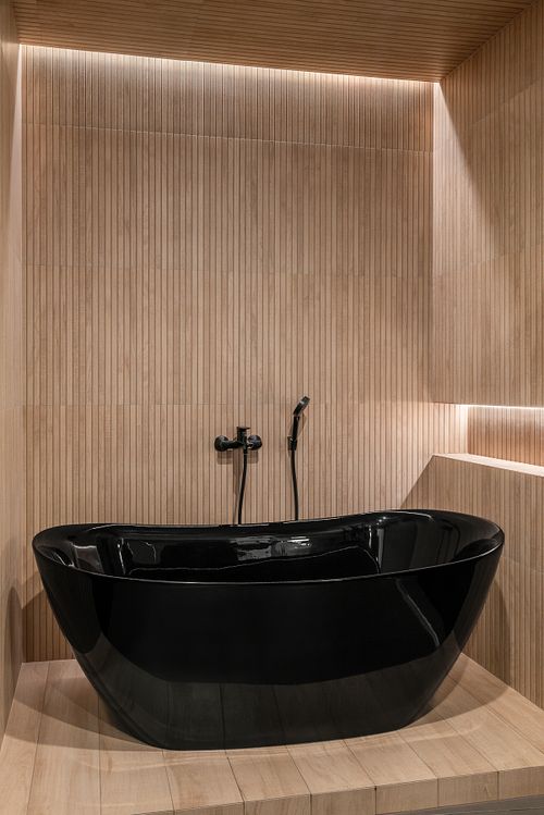 Edgy angle of bathroom with bathtub, soft light, and natural textures &ndash; Columna project