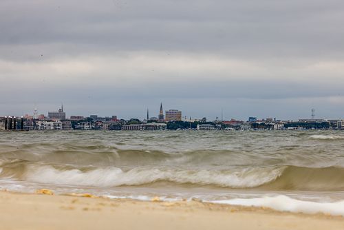 Charleston South Carolina skyline with ocean waves in foreground