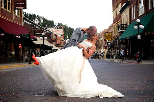 Groom dipping and kissing bride on Main Street - Deadwood Wedding Photographer