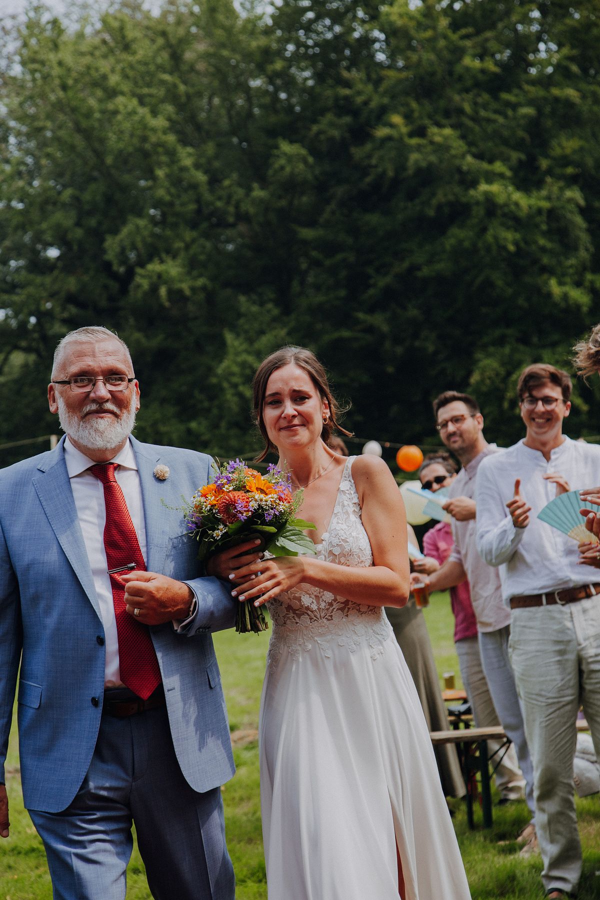 Vater begleitet die Braut zur Trauung oder zur &Uuml;bergabe, emotionaler Moment der Vater-Tochter-Bindung, Hochzeitsreportage im Freien in K&ouml;ln.