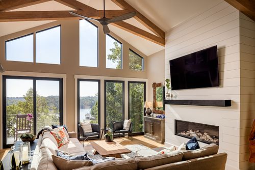 View across seating area to wall of windows through to the lake