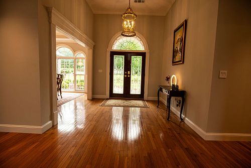 Illuminated entrance featuring wooden floors and stained glass