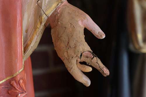Badly broken hand on the Sacred Heart statue from the backside