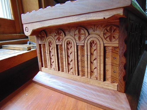 side panel of a carved cherry box with pintle hinge