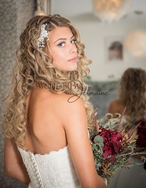 Model wearing a beautiful white wedding dress from Bridal Re-Loved Leicester, photographed inside the venue, captured by Weddings by Jermaine, with hair and makeup by Justaboutweddingshair and beauty, and accessories by Sydney Grace Bridal