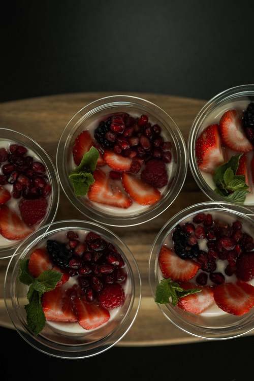 Prepared desserts served in small glass pots, photographed from above