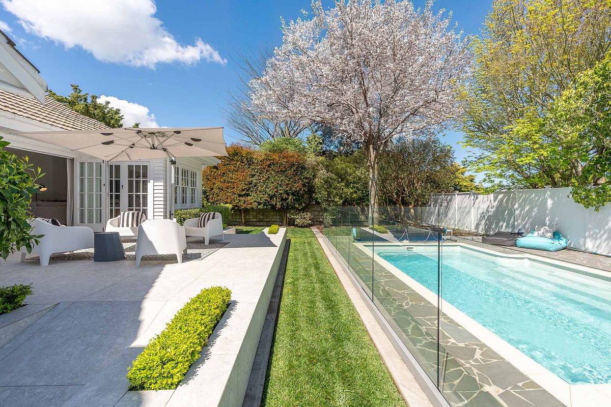 Architectural exterior photography of a luxury home and swimming pool in East Hamilton by Flax Cove Studio.