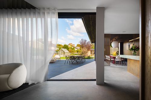 View from inside a house looking out to a courtyard through large sliding doors