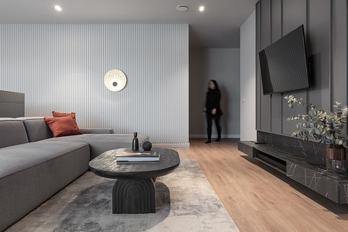 Minimalist high-end living room design with soft lighting and subtle human presence &ndash; Columna project