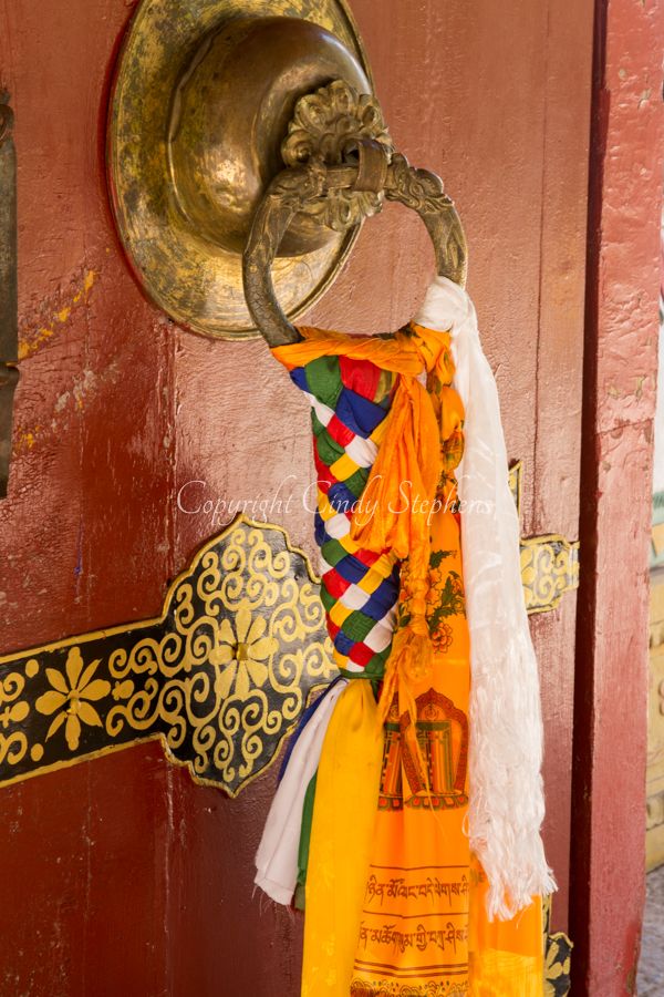 Tibetan door knocker tied with colorful scarfs