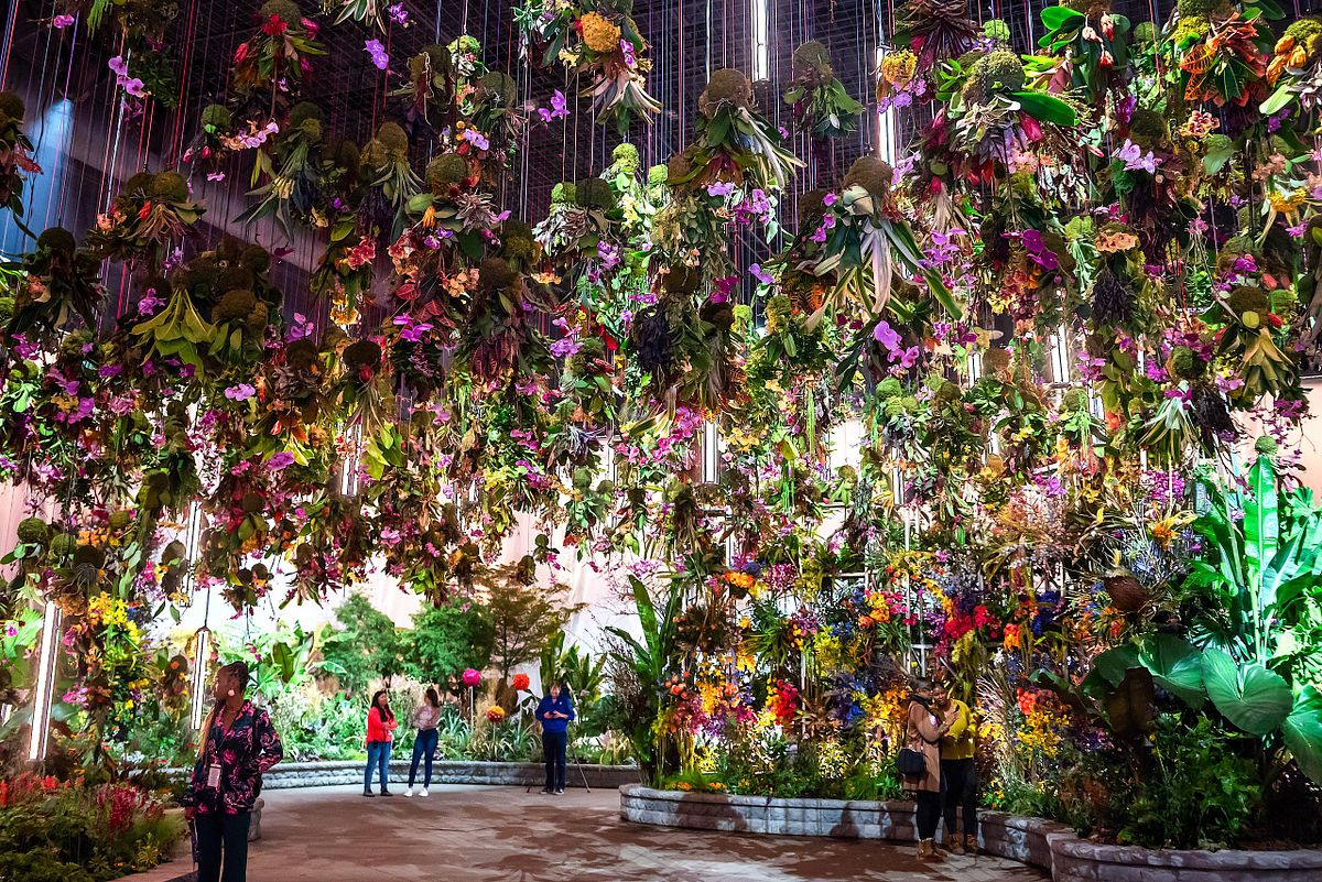 Event photography capturing a suspended floral canopy installation at the 2023 Philadelphia Flower Show, emphasizing large-scale exhibition design, immersive artistry, and the visual impact of botanical environments.