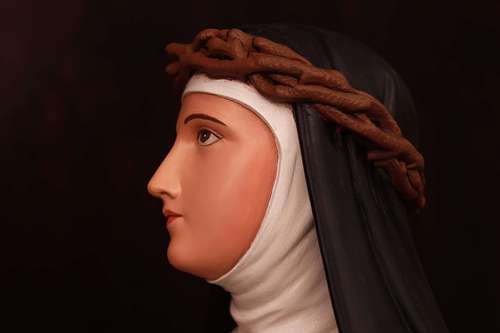 Saint Catherine Statue after repainting and restoration by Contrasts Woodcarving