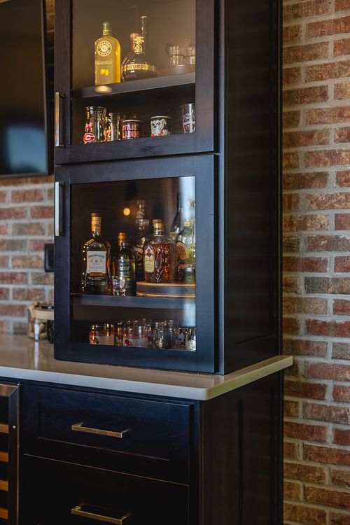 Glass door cabinet detail with brick wall