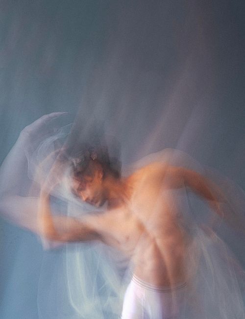 Editorial fashion image, model in motion, studio lighting, photographed by Jamila Filippone.