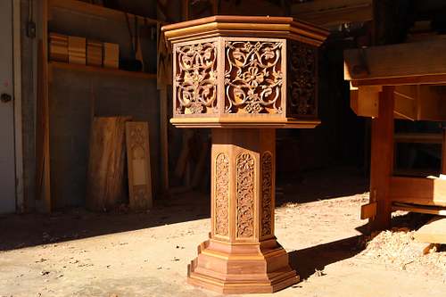 Baptismal font from a different angle showing the variety of flowers carved around it