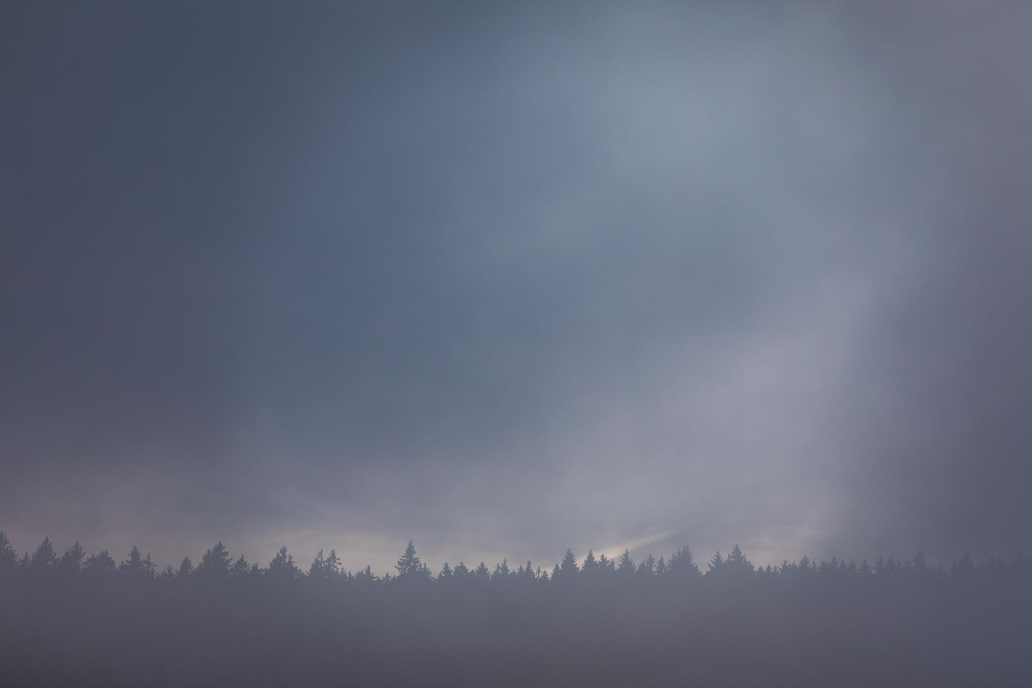 Layered mountain ridges in soft blue mist – atmospheric fine art photography