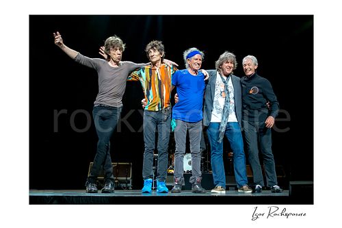 Horizontal color image of Mick Jagger, Ronnie Wood, Keith Richards, Mick Taylor and Charlie Watts of The Rolling Stones standing together on stage during a live concert finale